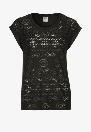 Haut noir semi-transparent à manches courtes avec col rond et motifs géométriques et floraux subtils, étiquette Vero Moda dans le col.