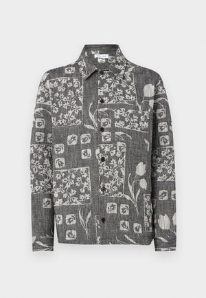Long-sleeve gray button-up shirt with black buttons, featuring abstract floral and geometric patchwork patterns in white.