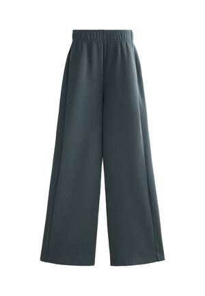 Wide-leg trousers in dark green, made of textured fabric. Features an elastic waistband and side seams, with a relaxed, flowing fit.