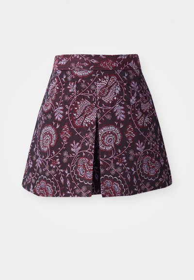 Floral-patterned skort in deep red and blue on a dark background, featuring a flared silhouette and a back pleat for ease of movement.
