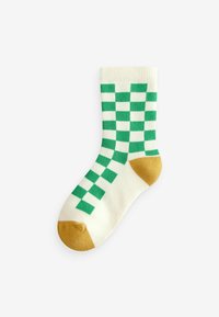 Weiße Socke mit grünem Karomuster, goldenen Akzenten an Zehen und Ferse. Hergestellt aus einem weichen Material, mit geripptem Bündchen für einen engen Sitz.