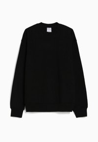 Sweat-shirt noir uni à manches longues avec col rond, poignets et ourlet côtelés, présenté sur fond blanc.