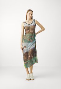 Maxi dress in sheer fabric showcasing a landscape print with vibrant colors and textures, featuring a scoop neckline and adjustable straps.