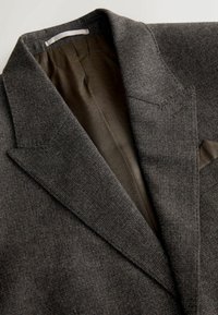 Dark brown textured blazer with notched lapels and patterned inner lining visible.