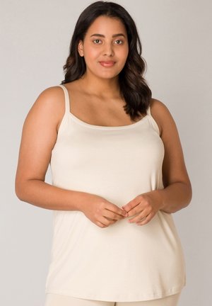 Crèmekleurige, mouwloze camisole met dunne bandjes, gemaakt van zachte stof, met een eenvoudige, losse pasvorm en ronde halslijn.