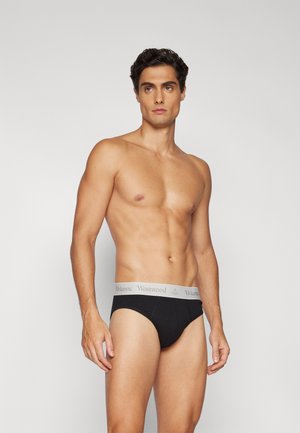 Culotte en coton noire avec une ceinture élastique gris clair portant le logo "Vivienne Westwood". Le design est simple et ajusté.