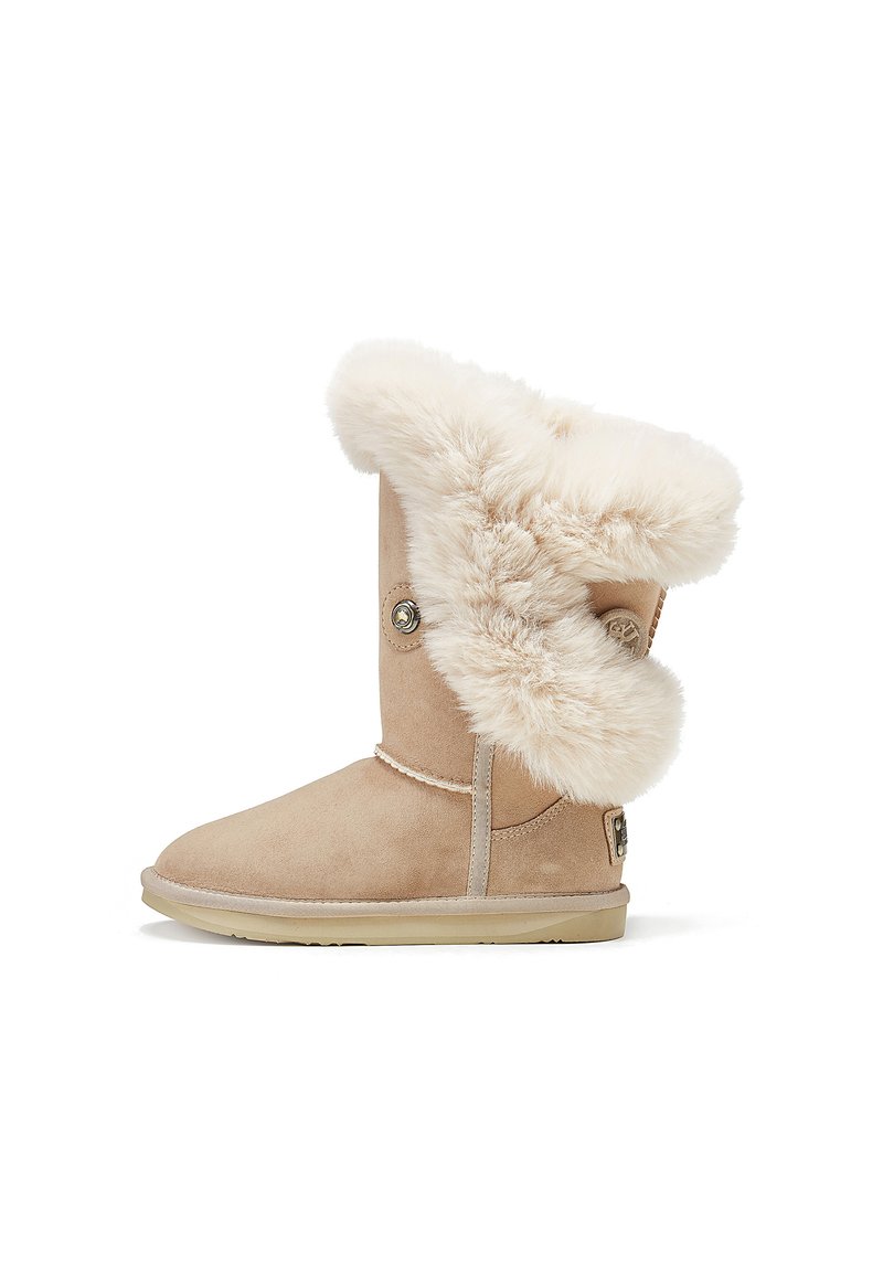 Beige suede ankle boot with a soft, white fur collar. Features a round button accent and a flat rubber sole. Smooth texture and rounded toe.