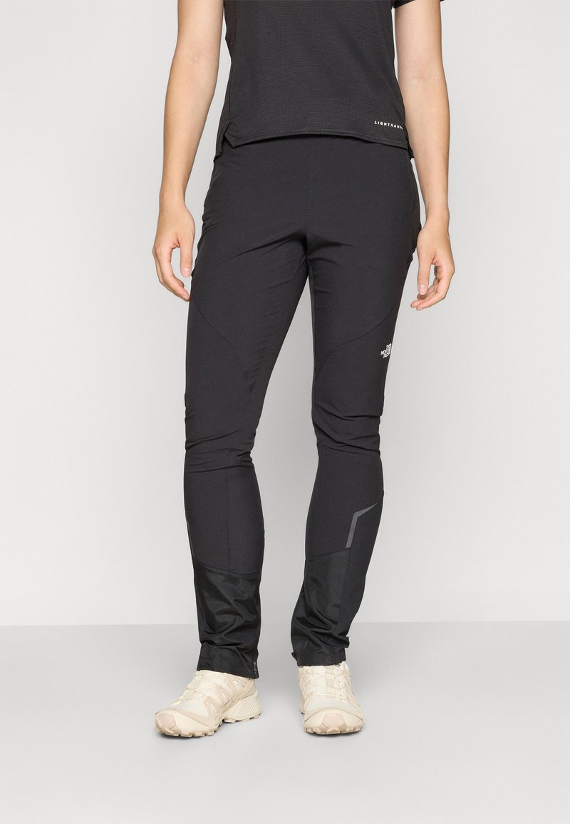 Black lightweight athletic pants featuring a tapered fit, elastic waistband, and reflective accents on the sides for visibility.