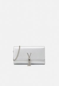 Silver leather clutch with chain strap, decorated with V-shaped metallic clasp and tassel detail on white background.