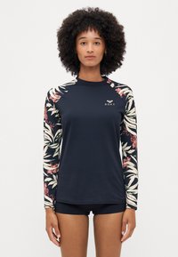 Haut de maillot de bain à manches longues avec un corps bleu marine et des manches à motifs floraux. Fabriqué en tissu extensible avec un logo sur la poitrine.