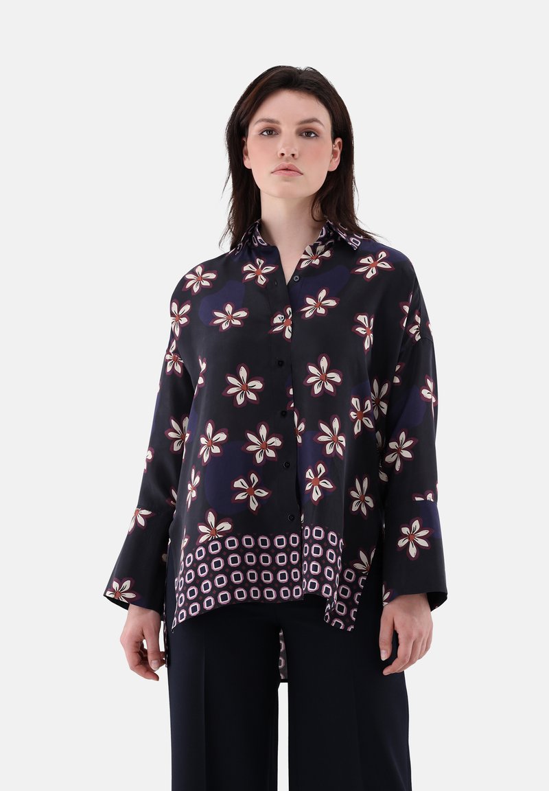 Navy floral button-up shirt with long sleeves, featuring white and burgundy flower patterns and a patterned hem. Crafted from a smooth fabric.
