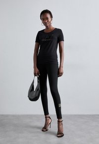 EA7 Emporio Armani Κολάν - Παντελόνια - black/gold-coloured