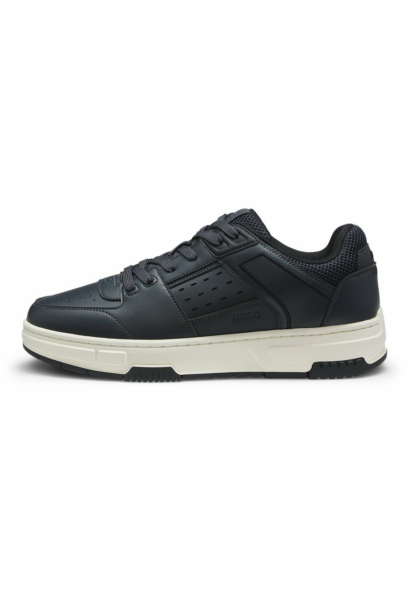 Black leather sneaker with mesh accents, perforated design, lace-up closure, and a contrasting white sole. Lightweight and durable construction.