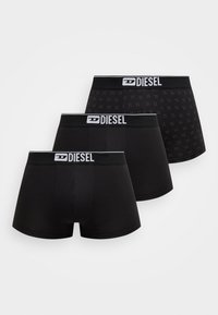 Three pairs of black boxer briefs featuring varying designs, including a solid color and one with a subtle pattern, all with logoed waistbands.