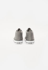 Sneakers alti in tela grigia con suole in gomma bianca, featuring un'etichetta rotonda con logo e cuciture a contrasto sui lati.