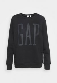 Sudadera negra de cuello redondo, con un gran logo tonal "GAP" en el centro. Fabricada en tejido suave con puños y dobladillo acanalados.