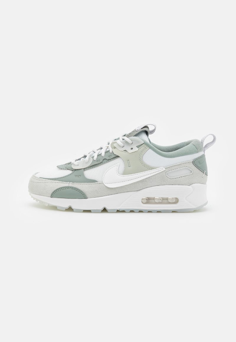 white and green nike trainers