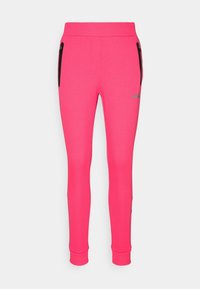 Fittende roze sweatpants van zacht materiaal, met zijzakken met rits en een geribde tailleband en boorden. Zilveren logo detail aan de zijkant.