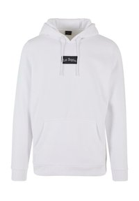 Hoodie blanc en tissu doux avec une poche kangourou, des cordons de serrage et une étiquette noire avec le texte "Los Angeles" sur le devant.