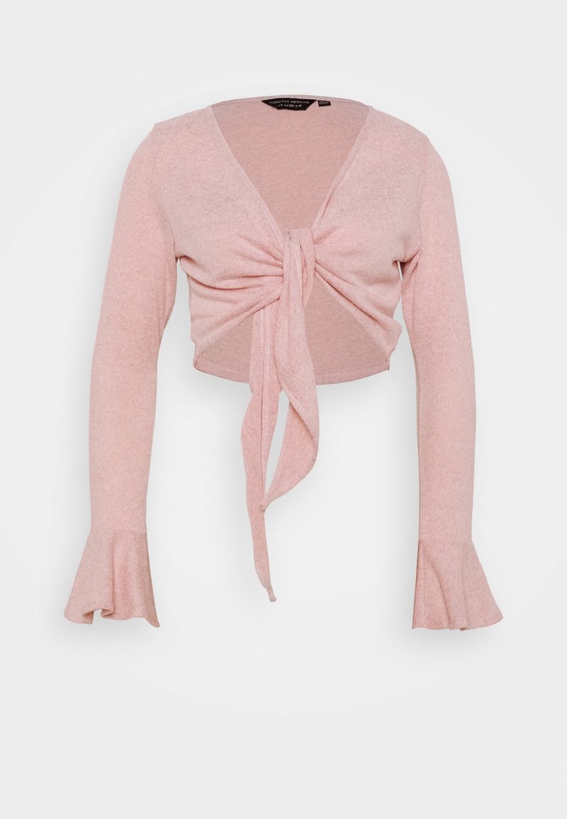 Mjukt rosa långärmad cropped topp med knytning fram och utsvängda ärmmuddar, tillverkad av lättstickad tyg.