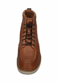 Brown leather ankle boot with round toe, tonal stitching, and brown laces. Features metal eyelets and a white rubber sole.