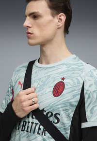 Valk blue patterned jersey with black sleeves, featuring a red club logo, a star accent, and bold black text at the chest.
