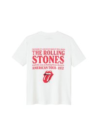 T-shirt en coton blanc avec un texte rouge vif : "THE ROLLING STONES AMERICAN TOUR - 1972" et un logo de langue rouge en dessous du texte.