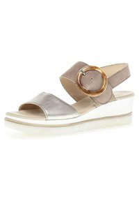 Wedge sandal featuring a silver leather wide strap, taupe suede ankle strap with a round wooden accent, and a cleated white sole for grip.