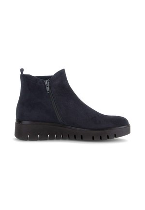 Black suede ankle boot with side zipper and thick ridged rubber sole for traction and comfort, displayed in side profile.