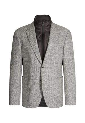 Blazer gris à motif pied-de-poule, avec une couche intérieure zippée. Tissu texturé, deux poches avant et une fermeture par un seul bouton.