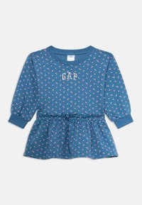 Vestido de bebé de manga longa azul com pequeno padrão de flores cor-de-rosa, cintura franzida com laço e logo "GAP" no peito.