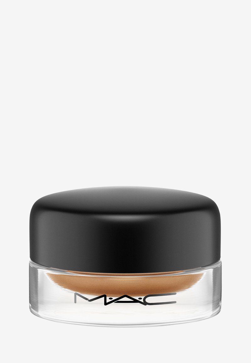 Glazen pot met een zwarte ronde deksel, gevuld met een bruine crème. Heeft een zachte textuur en het MAC-logo aan de voorkant.