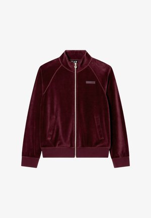 Giacca con zip in velluto color bordeaux scuro, polsini e orlo a costine, due tasche frontali e una piccola toppa rettangolare sul petto.