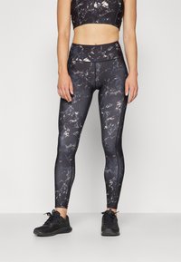 Black marble-patterned activewear set featuring a cropped top and high-waisted leggings. Smooth, stretchy fabric with fitted design.