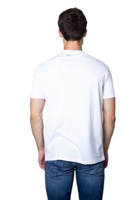 White short-sleeve t-shirt with a crew neck, made of cotton, displayed from the back. Features a small brand label at the neckline.