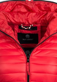 Red padded jacket with a shiny texture and horizontal stitching. Features a black zipper and branded label inside the collar.