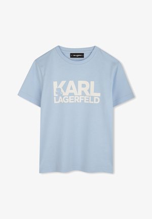 T-shirt en coton bleu clair à manches courtes, avec un grand texte blanc sur le devant qui indique "KARL LAGERFELD".
