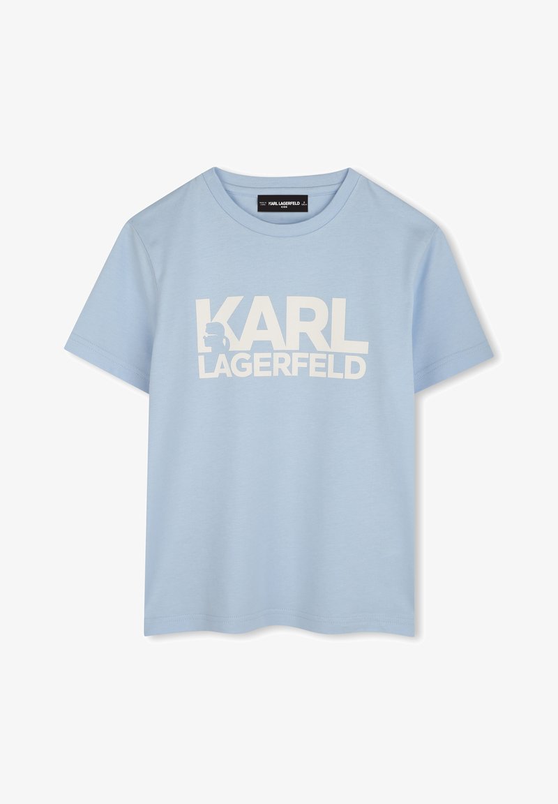T-shirt en coton bleu clair à manches courtes, avec un grand texte blanc sur le devant qui indique "KARL LAGERFELD".