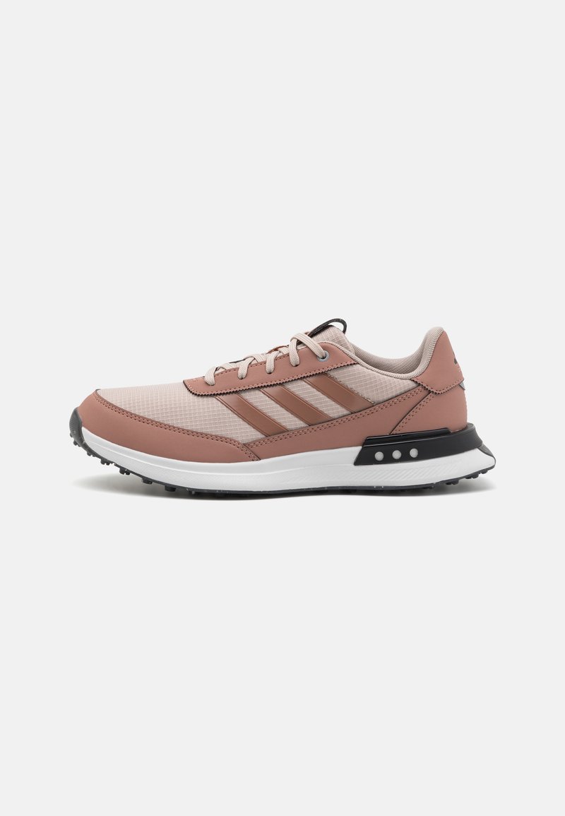 Light pink athletic shoes with beige mesh upper, brown leather accents, black sole, and three stripes logo. Rounded toe and lace-up design.