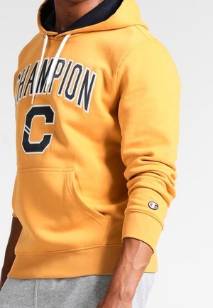 Gelbe Baumwollkapuzenjacke mit schwarzem "Champion"-Text und Logo. Enthält Kordeln, eine Fronttasche und gerippte Bündchen.