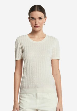 Kortærmet, cremerfarvet strikbluse med et tekstureret mønster, rund halsudskæring og tætsiddende pasform. Letvægtsstof med en subtil gennemsigtighed.