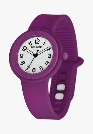 Lila Silikon-Uhr mit rundem Ziffernblatt, weißem Zifferblatt, schwarzen Stundenmarkierungen und schwarzen Zeigern. Verfügt über ein strukturiertes Armband und eine Druckknopfkrone.