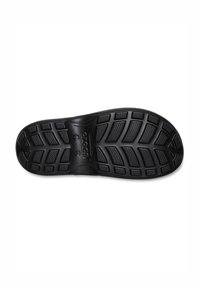 Semelle de chaussure en caoutchouc noir avec un motif de semelle, comprenant des reliefs et des rainures pour la traction et l'adhérence. Forme plate avec des bords arrondis.