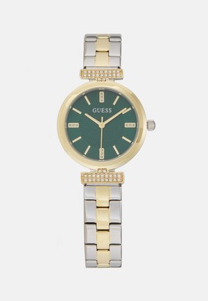 Montre en métal doré et argenté avec un cadran vert, arborant un motif texturé, des accents en cristal et un boîtier rond. Bracelet en maillons.