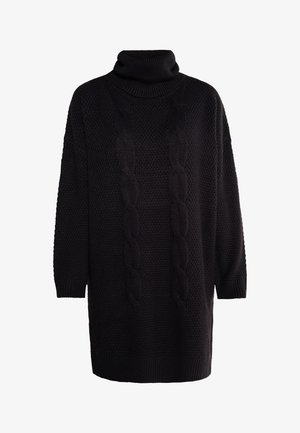 Black knitted sweater dress featuring a high turtleneck, textured surface, and cable-knit patterns down the front. Relaxed fit, ¾ sleeves.