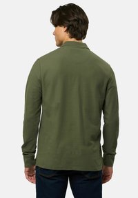 Hosszú ujjú pólóing olívazöld pamutból, texturált felülettel, hajtókás nyakkal és egyenes aljzattal.