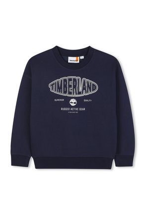 Sweatshirt marine en coton doux, arborant un grand logo blanc "TIMBERLAND" avec un emblème d'arbre, col rond et poignets côtelés.