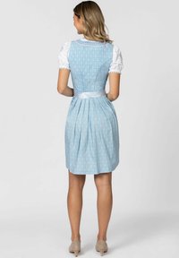 Light blue, patterned dress with a fitted bodice, pleated skirt, and satin ribbon belt. Short white sleeves with lace trim.