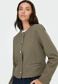 Brown houndstooth jacket with a round neckline, gold-tone buttons, and two front pockets; fitted design and textured fabric.