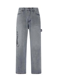 Light gray denim jeans with a relaxed fit, featuring a side pocket, bold black graphic on the left leg, and subtle fading throughout.